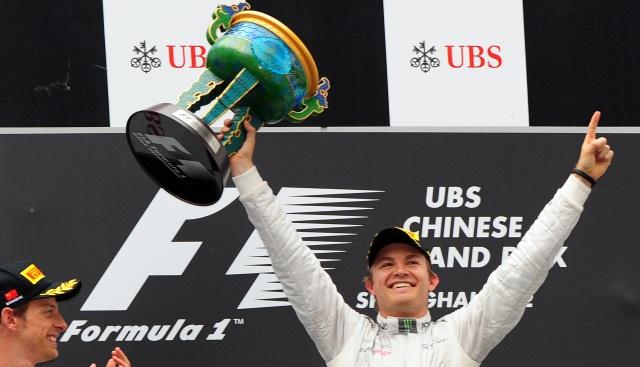 Mercedes-AMG driver Nico Rosberg (R) of Germany celebrates winning Formula One's Chinese Grand Prix beside second-placed McLaren-Mercedes driver Jenson Button (L) of Britain at the Shanghai International Circuit on April 15, 2012.       AFP PHOTO / Mark RALSTON
