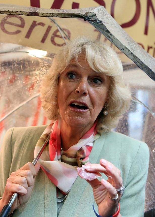 Camilla-Duchess-of-Cornwall-tastes-a-piece-of-salami-1917749