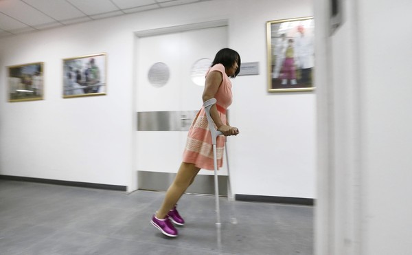 Qian Hongyan, 18, tests out her new prosthesis at China Rehabilitation Centre in Beijing