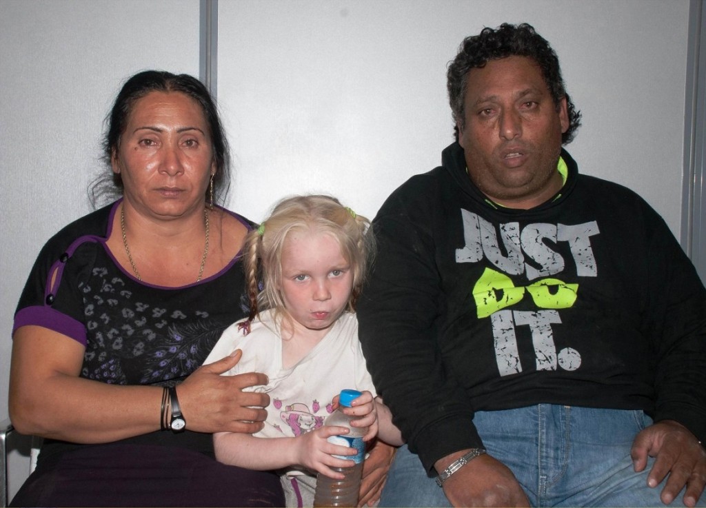 A Roma couple and a girl found living with them in central Greece, are seen in a handout photo distributed by the Greek police