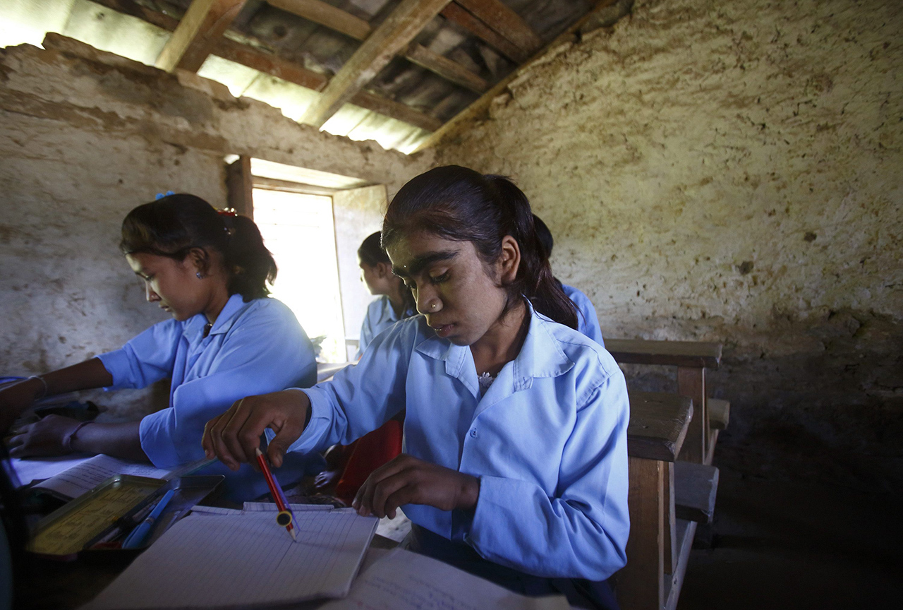 Manjura Budhathoki studies inside a classroom at a school in Kharay, Dolkha District