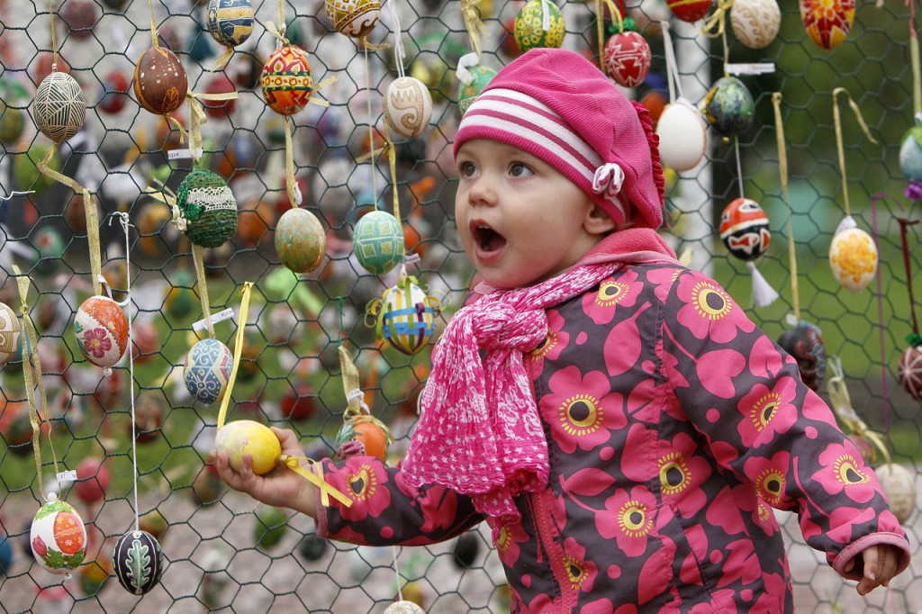 A girl walks past an installation made of Easter eggs in Kiev