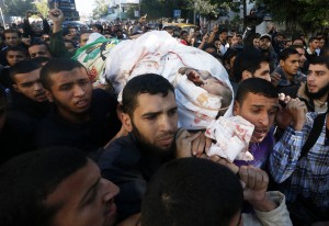 Palestinians carry the body of Ahmed Al-Jaabari, Hamas's military mastermind, during his funeral in Gaza City