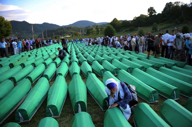 A Bosnian woman mourns over the cofin of