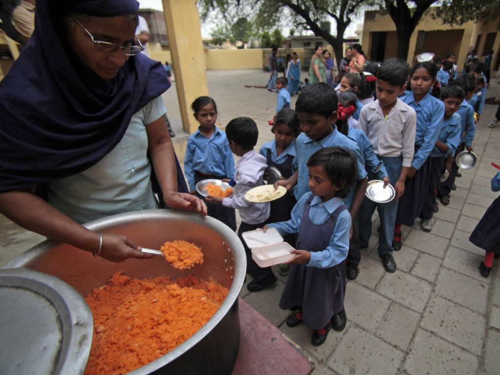 jammu-india-children-stand-in-line-to-receive-a-free-mid-day-meal-made-of-sweetened-rice-at-a-government-school
