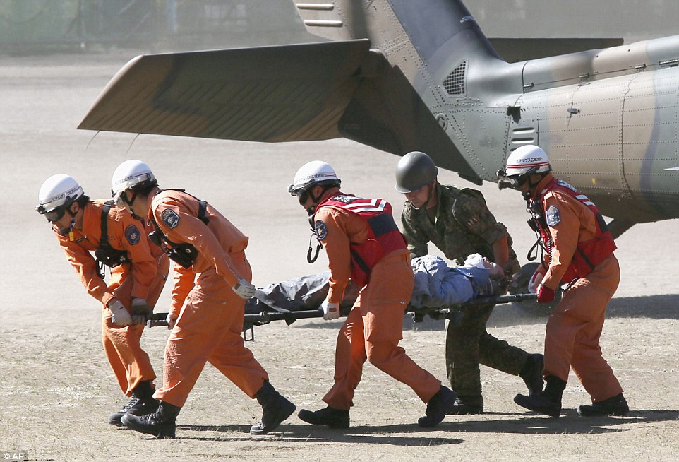 1411894653800_wps_28_Rescue_workers_carry_a_cl