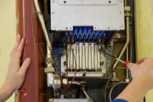 hands of a plumber repairing a gas heating