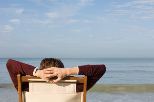 man-relaxing-in-chair-on-beach