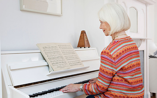 A senior female playing the piano