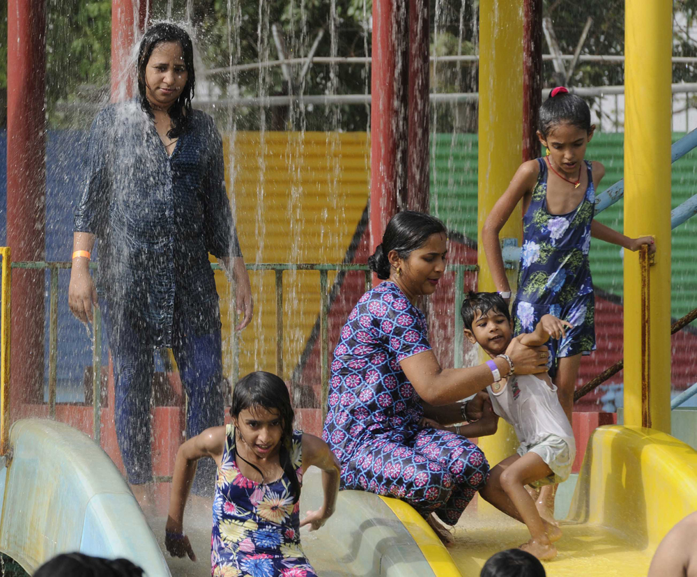 NEW DELHI, INDIA - MAY 24: People enjoying at a water park "Delhi Rides" at Kalindi Kunj during a hot weather as Delhi/NCR experienced yet another scorching day, on May 24, 2015 in New Delhi, India. The national capital sizzling today as heat wave-like conditions prevailed across the city with mercury hovering above 44.7 degree Celsius, making life tough for the Delhiites. (Photo by Sonu Mehta/Hindustan Times via Getty Images)