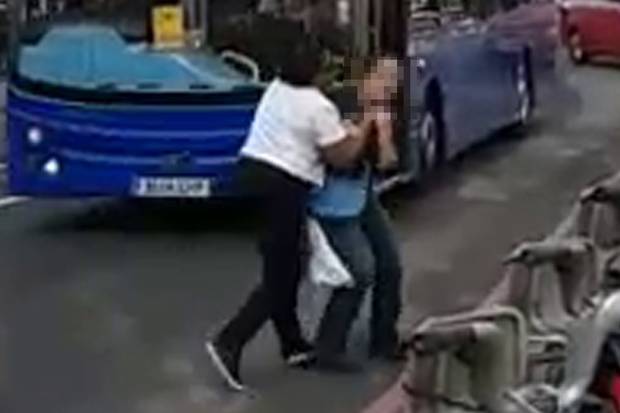 London tour bus driver leaps on to street to 'throttle woman who filmed her run red light'   Copyright Evening Standard