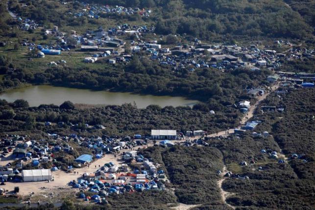An aerial view of a field called the "New Jungle" with tents and makeshift shelters where migrants and asylum seekers stay is seen in Calais,