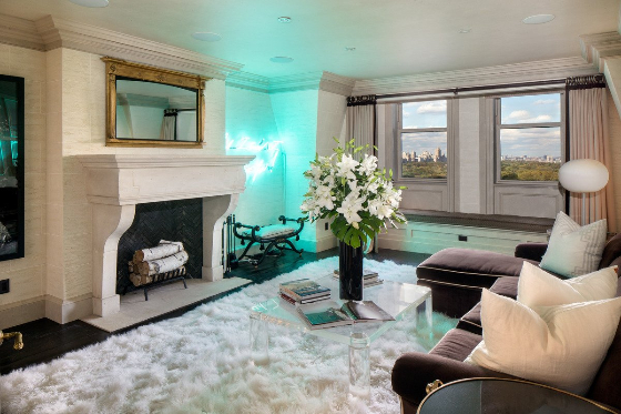 and-here-is-a-sitting-room-with-a-fireplace-blue-neon-lights-and-a-view-of-central-park