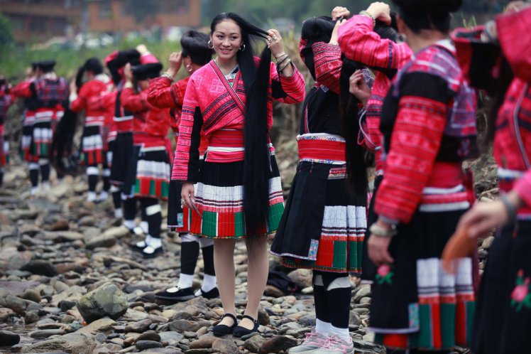 GUILIN, CHINA - APRIL 09: (CHINA OUT) Yao women comb hair during the Long Hair Festival at Longji Huangluo Yao Village on April 9, 2016 in Guilin, Guangxi Zhuang Autonomous Region of China. Yao people celebrated the first Long Hair Festival during the Double Third Festival on March 3 of the Chinese calendar. (Photo by VCG/VCG via Getty Images)