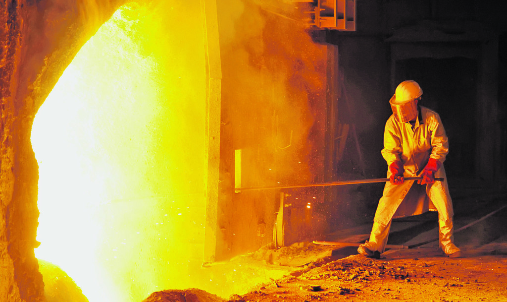 worker takes a sample at steel company