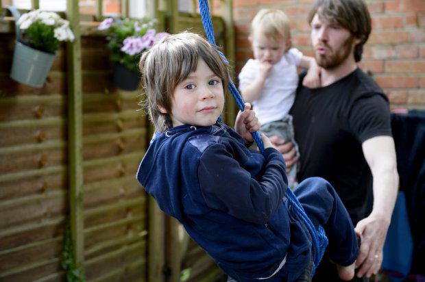 **PLEASE NOTE THERE IS AN EMBARGO UNTIL MONDAY 18 JULY 00:01AM** *** EXCLUSIVE - VIDEO AVAILABLE *** BRIGHTON, SUSSEX - JUNE 10: Matt Allen and his son Ulysses, five, on a swing, with his daughter Ostara in their back garden in Brighton, Sussex on 10 June 2016. Parents Adele and Matt Allen believe in an all-natural approach to bringing up their children - so much so they refuse modern medicine, traditional schooling and encourage full-term breastfeeding. Adele, 32, and Matt, 33, from Brighton, call their parenting style ëOff-Grid Parentingí and their children Ulysses, five and Ostara, one, are therefore both still breastfed, have never visited a doctor and will not attend a mainstream school. When Adele, a writer, fell pregnant with her son, the coupleís controversial methods felt completely natural to them. She said: ìOff-grid is moving towards self sustainability and being a bit more free range and less institutionalised.î Matt said: ìWe did collect a lot of information but essentially it was just this feeling.î Adele gave birth to both her children, completely unassisted and with no medical intervention with only her husband Matt by her side. PHOTOGRAPH BY Jon Short / Barcroft Images London-T:+44 207 033 1031 E:hello@barcroftmedia.com - New York-T:+1 212 796 2458 E:hello@barcroftusa.com - New Delhi-T:+91 11 4053 2429 E:hello@barcroftindia.com www.barcroftmedia.com